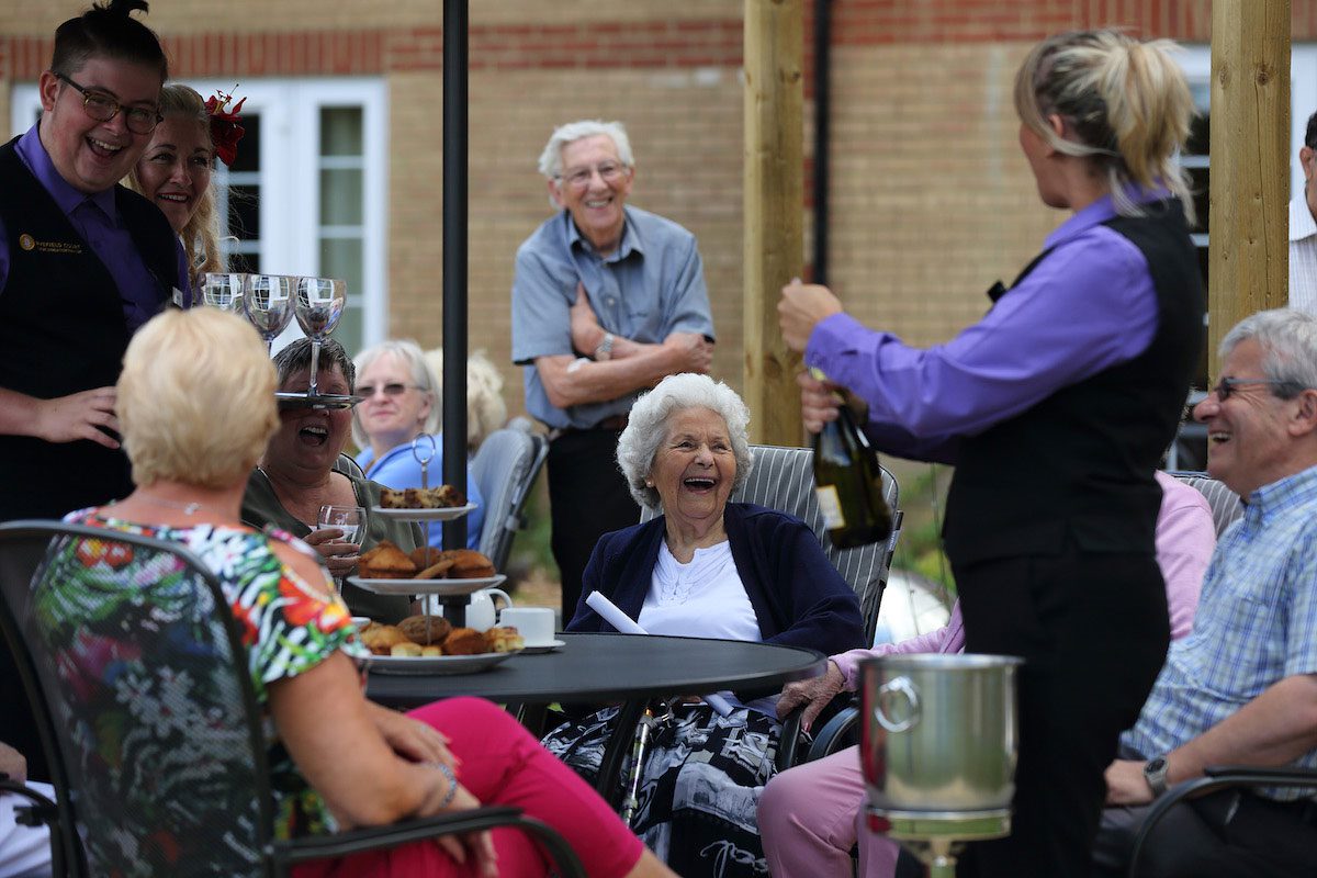 Smiling residents outside at care home